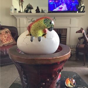 R.Miranda signed hatching jungle parrot in cracked egg ceramic figurine